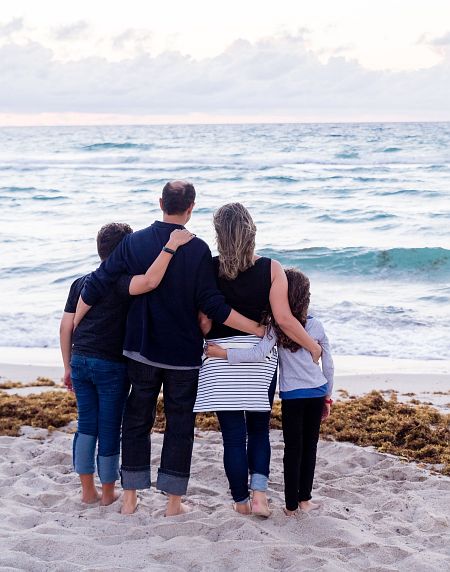 A family standing by the ocean